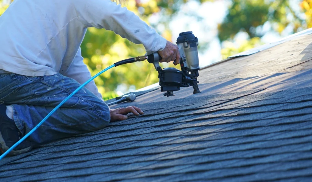 contractor fixing a roof damage repair