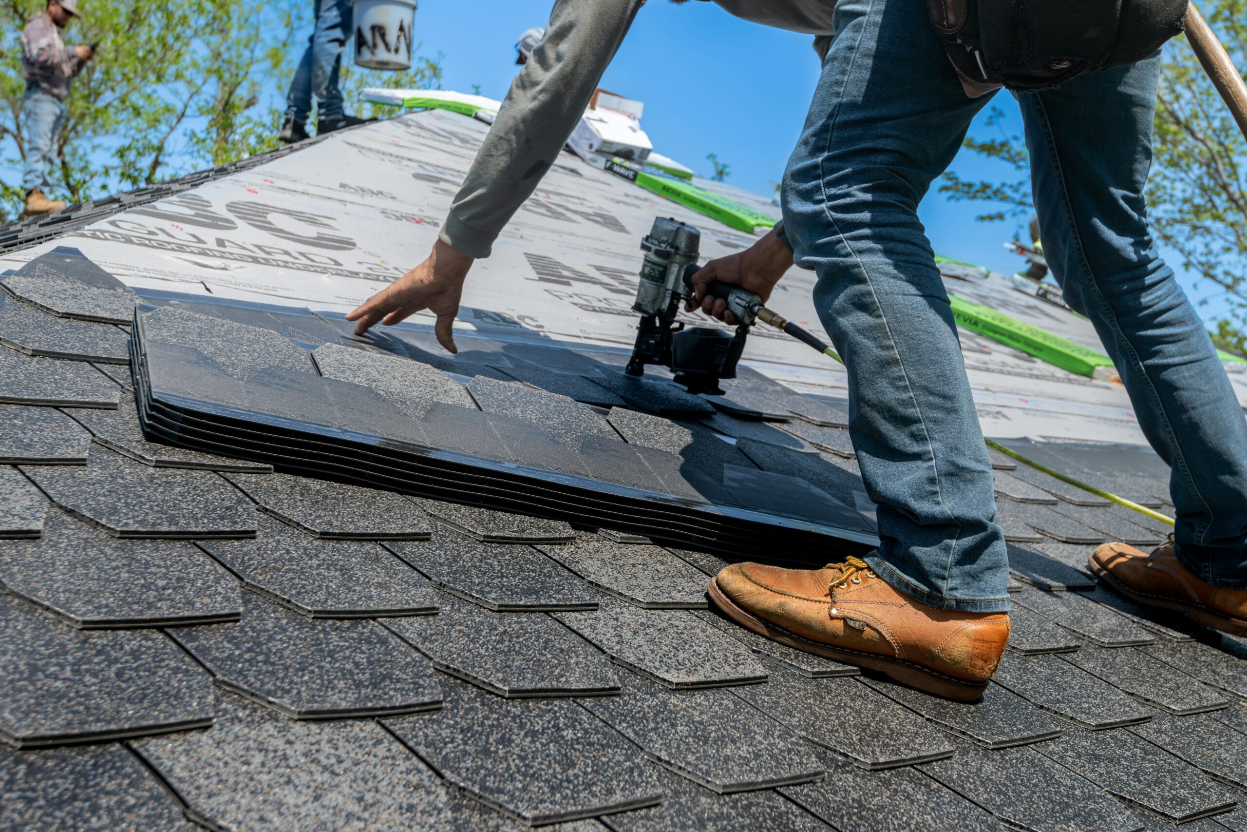 Professional roofing contractor inspecting a roof with expertise, wearing safety gear and looking professional